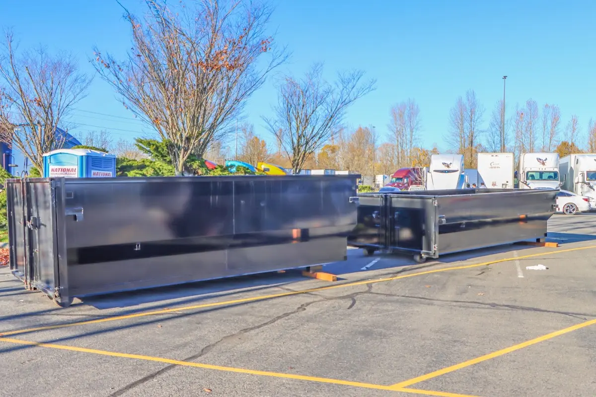 Professional dumpster rental service with roll-off container on residential driveway in Corry